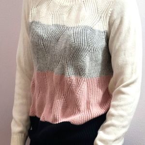 Beautiful sweater. Medium size. Beige with gray, pink and black stripes.